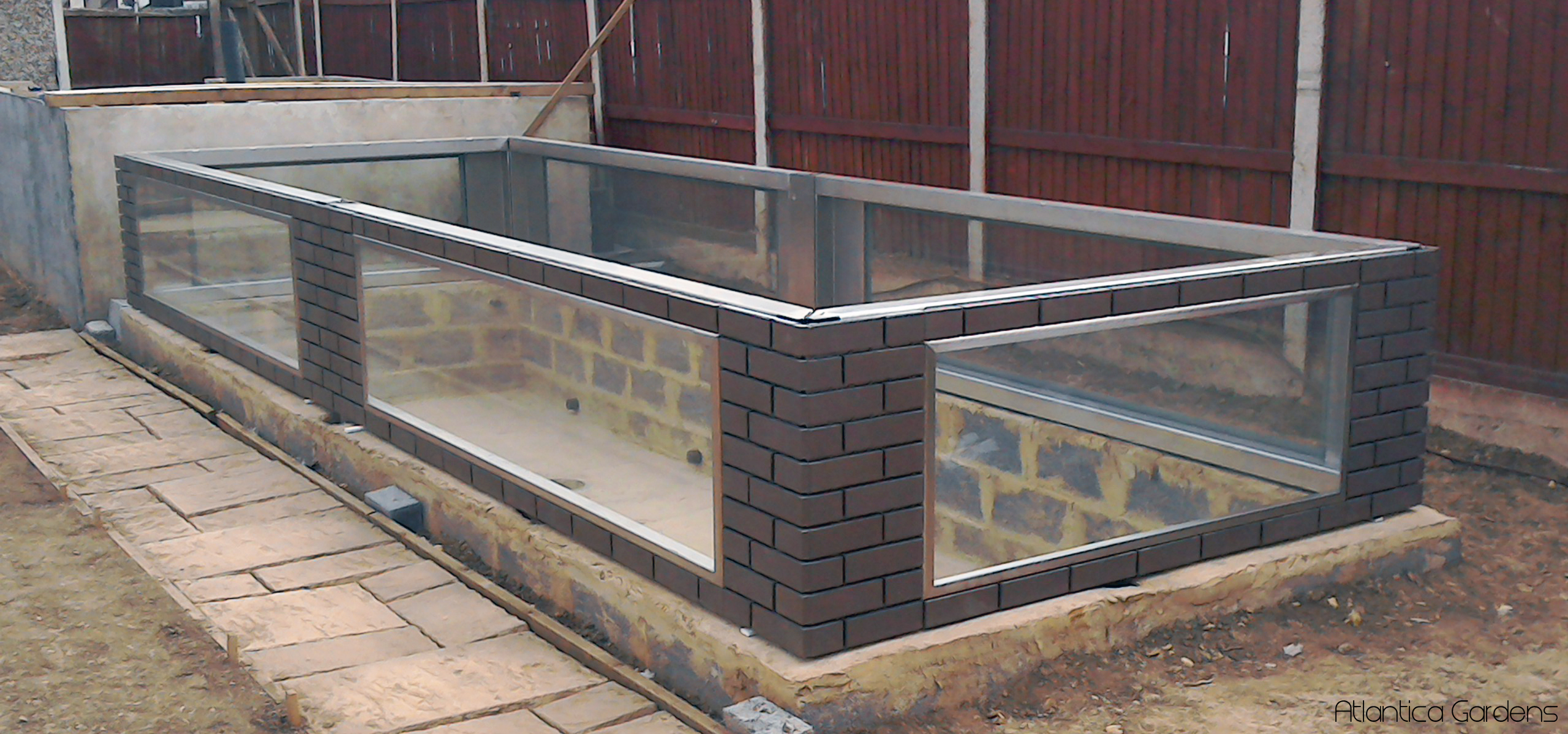 large bolt together instant pond.  brick and stainless steel with windows